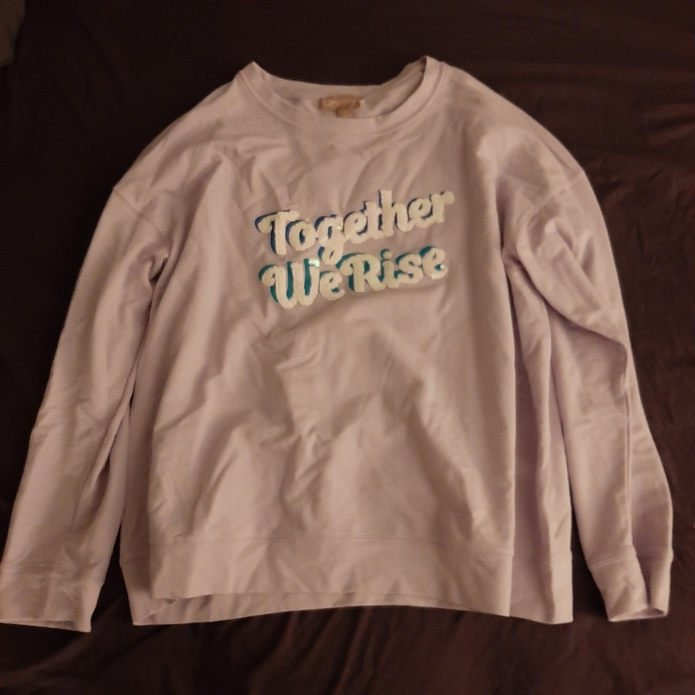 Pink sweatshirt with "Together We Rise"